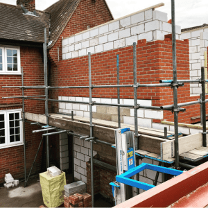Extension builders Colchester erecting scaffolding on house